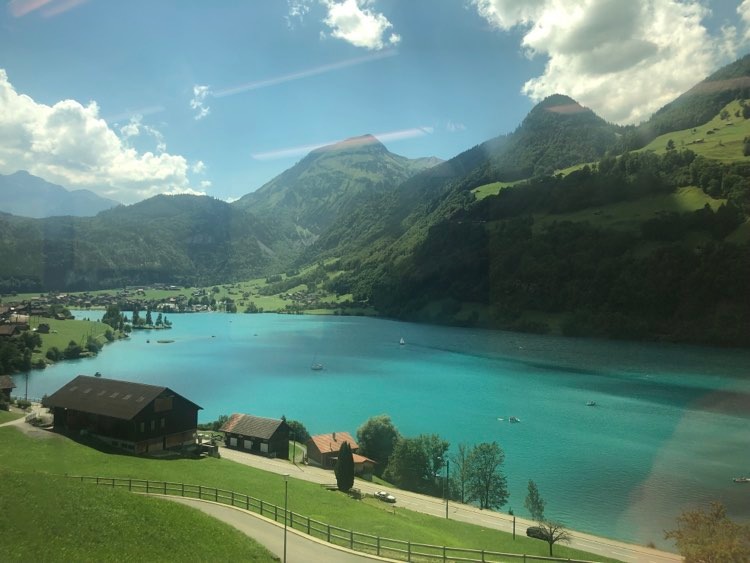 Alp view from a regional train in Switzerland. Photo.